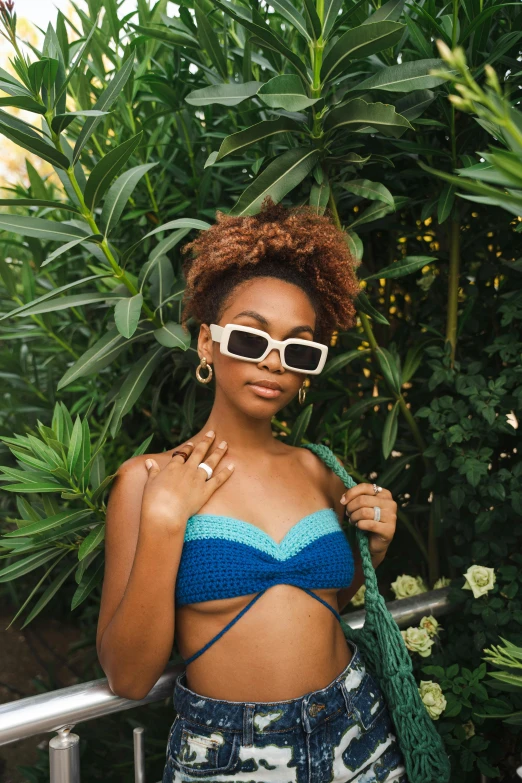 a woman in a bikini top and sunglasses posing for a picture, inspired by Whitney Sherman, trending on pexels, renaissance, ashteroth, blueish, sydney sweeney, loosely cropped