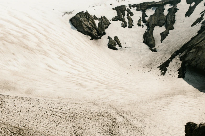 a man riding a snowboard down a snow covered slope, an album cover, by Daniel Seghers, unsplash contest winner, extremely detailed sand, erosion algorithm landscape, glacier coloring, white