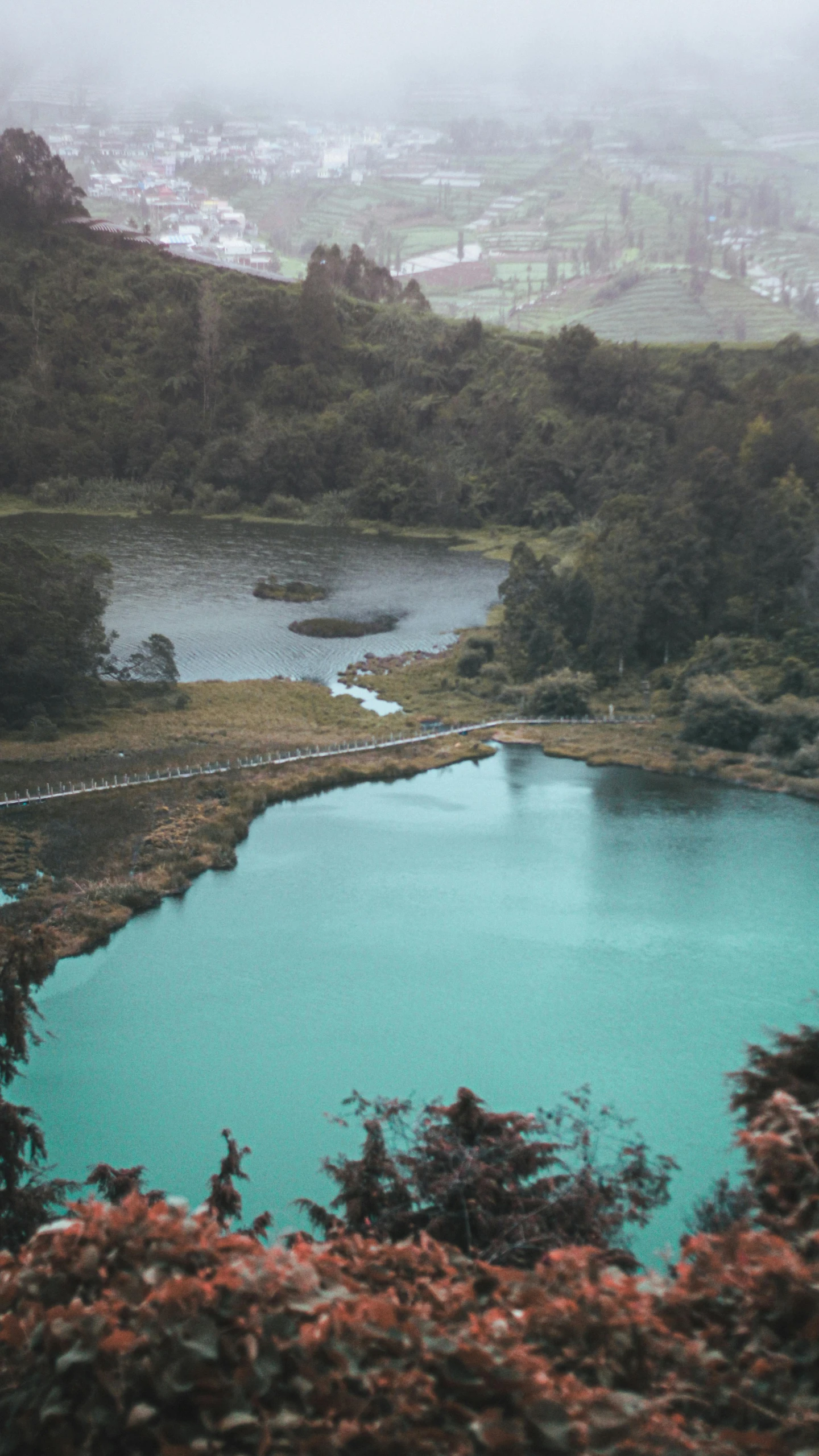 a large body of water sitting on top of a lush green hillside, an album cover, inspired by Elsa Bleda, pexels contest winner, hurufiyya, indonesia, lake blue, overview, gif