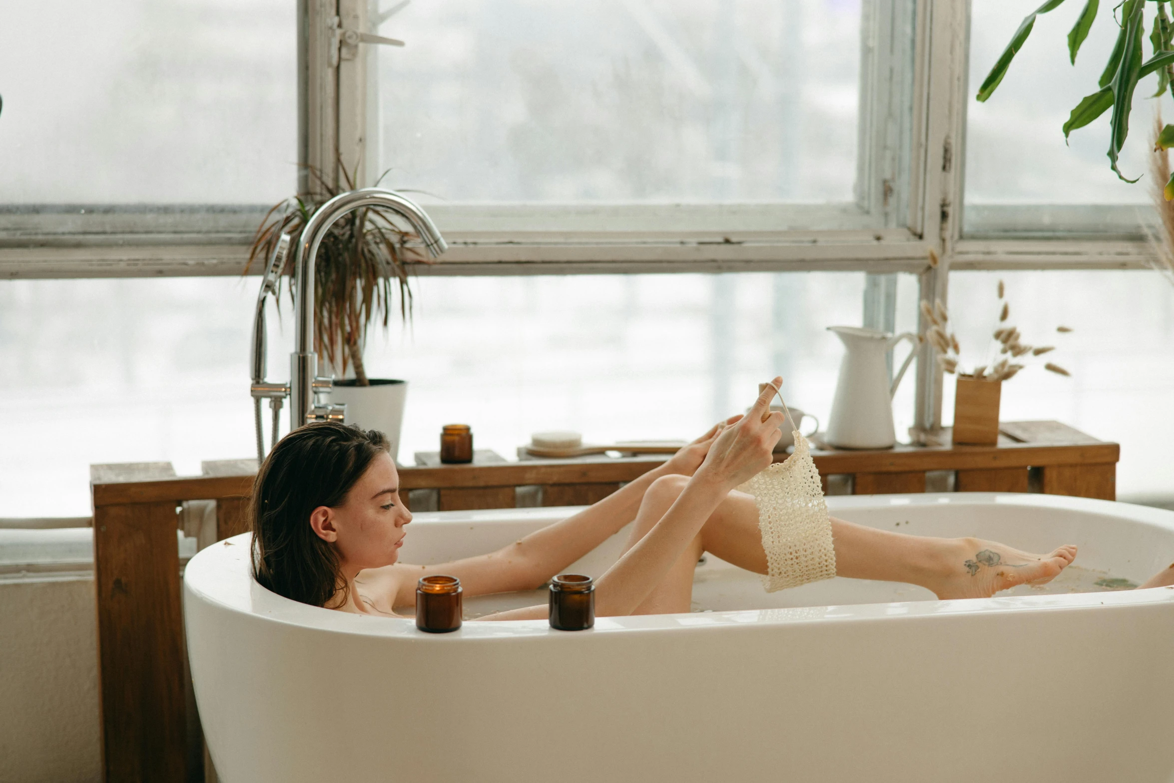 a woman sitting in a bathtub next to a window, trending on pexels, manuka, candy treatments, on a hot australian day, female floating