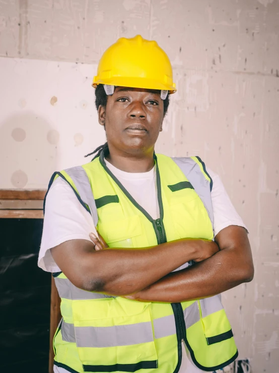 a man wearing a hard hat and safety vest, an album cover, pexels contest winner, black female, !female, portrait image, thicc build