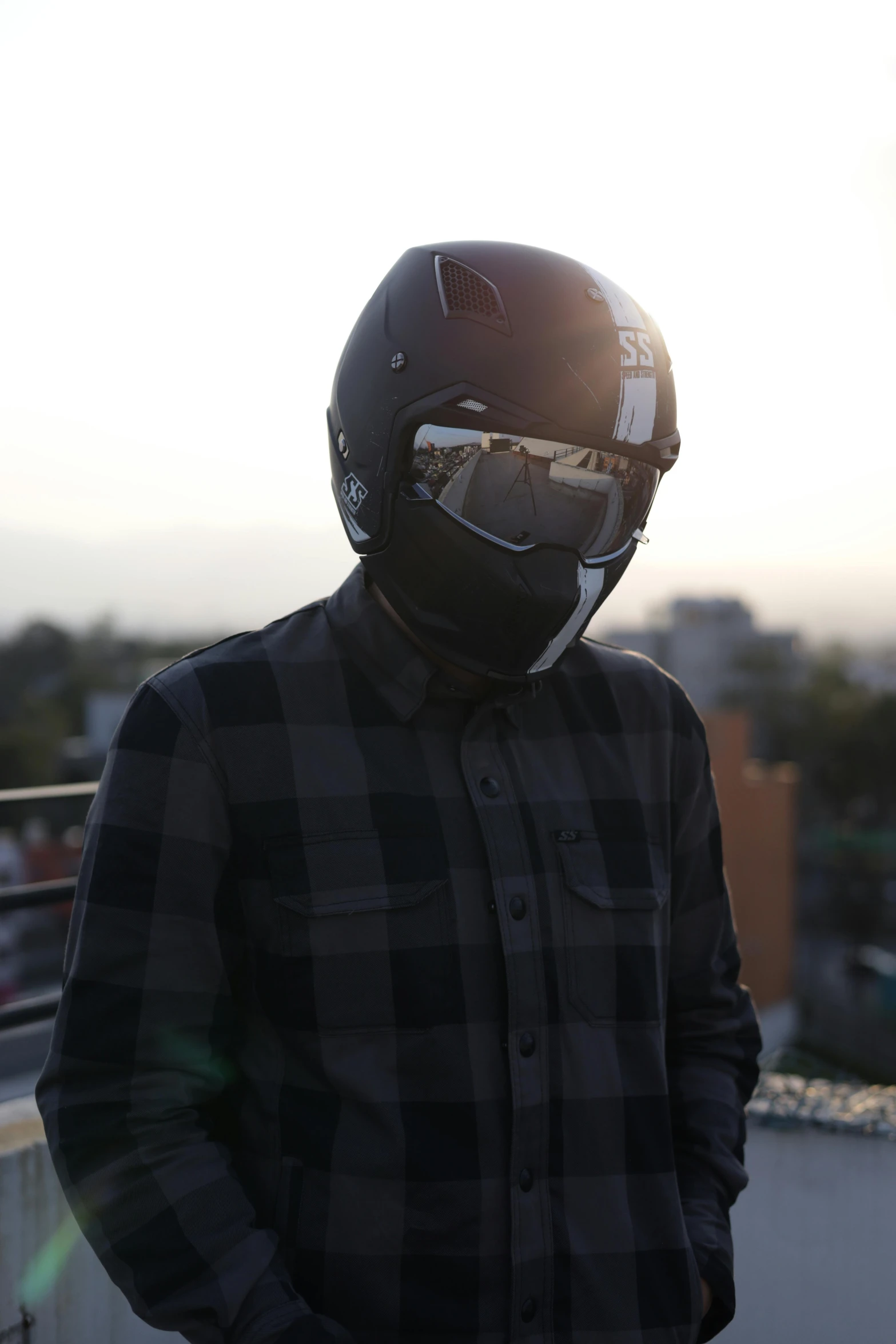 a man wearing a helmet standing on top of a roof, inspired by Cam Sykes, featured on reddit, chrome mask, reflective lens, transparent black windshield, profile image