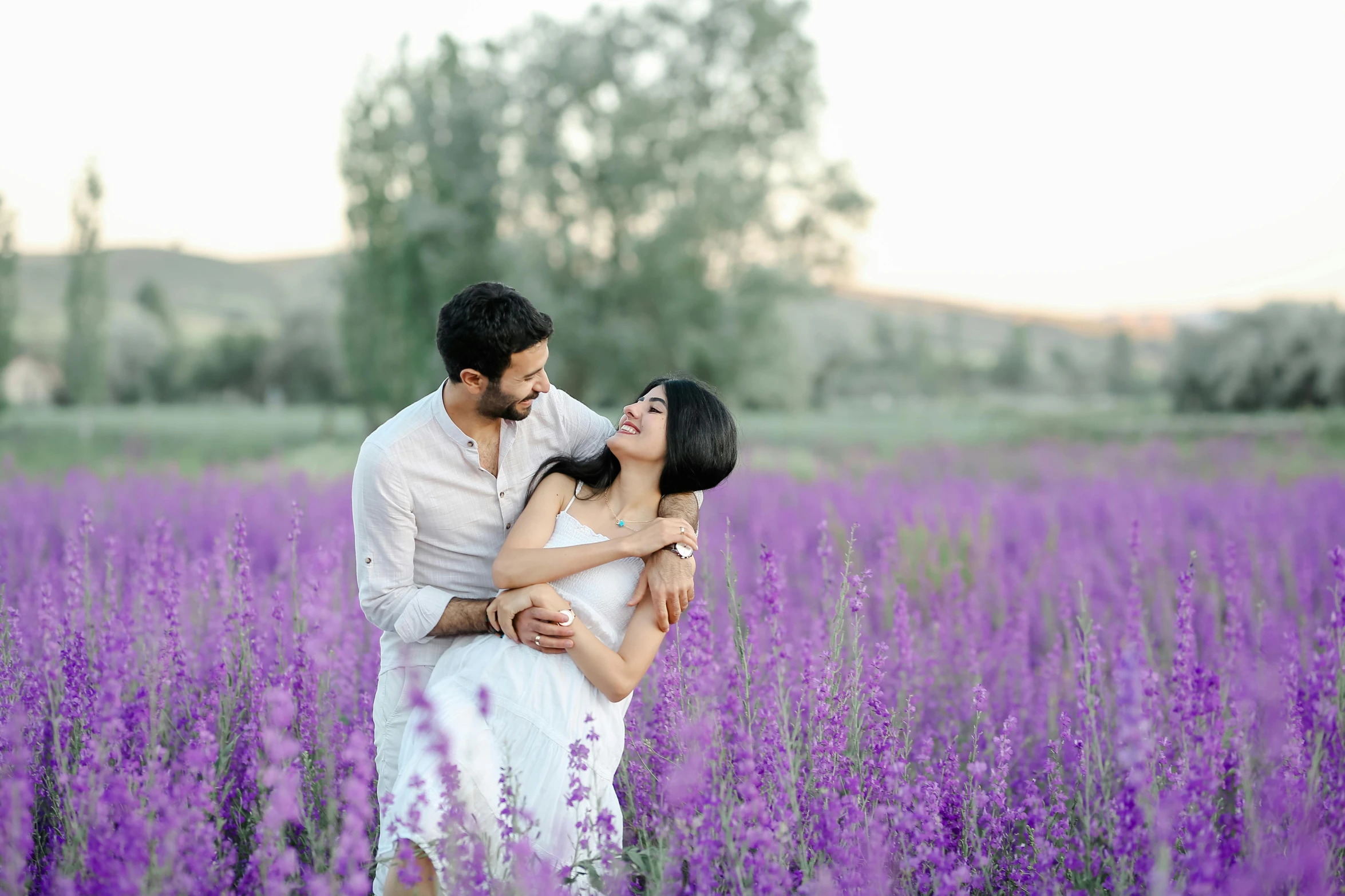 a man and woman standing in a field of purple flowers, pexels contest winner, ayanamikodon and irakli nadar, white, background image, cute photo