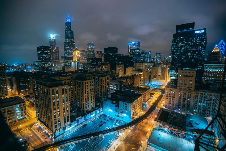 an aerial view of a city at night, by Andrew Domachowski, unsplash contest winner, location [ chicago ( alley ) ], golden and blue hour, wide high angle view, 2000s photo