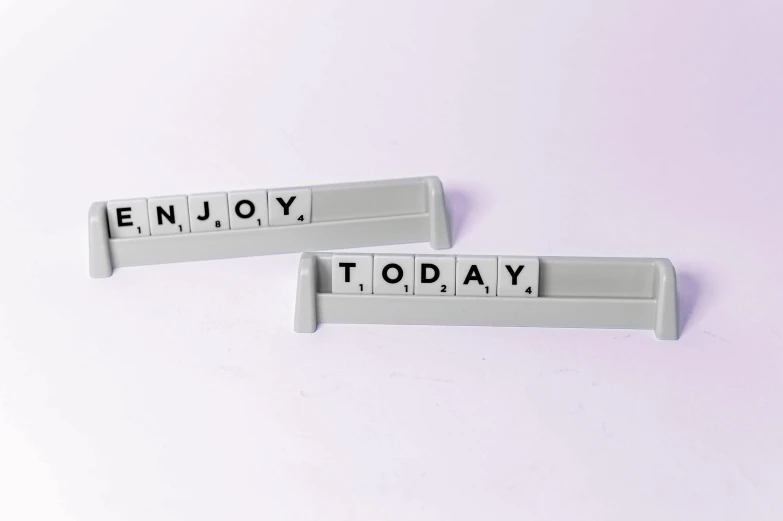 a couple of magnets sitting on top of a white surface, a picture, expressing joy, keyboards, tomorrow, grey