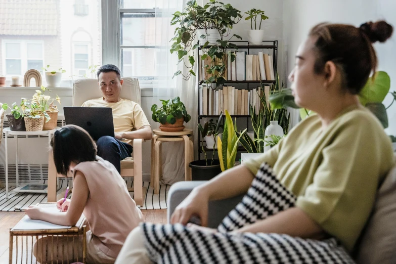 a group of people sitting on a couch in a living room, home office, hoang lap, centralised, profile image