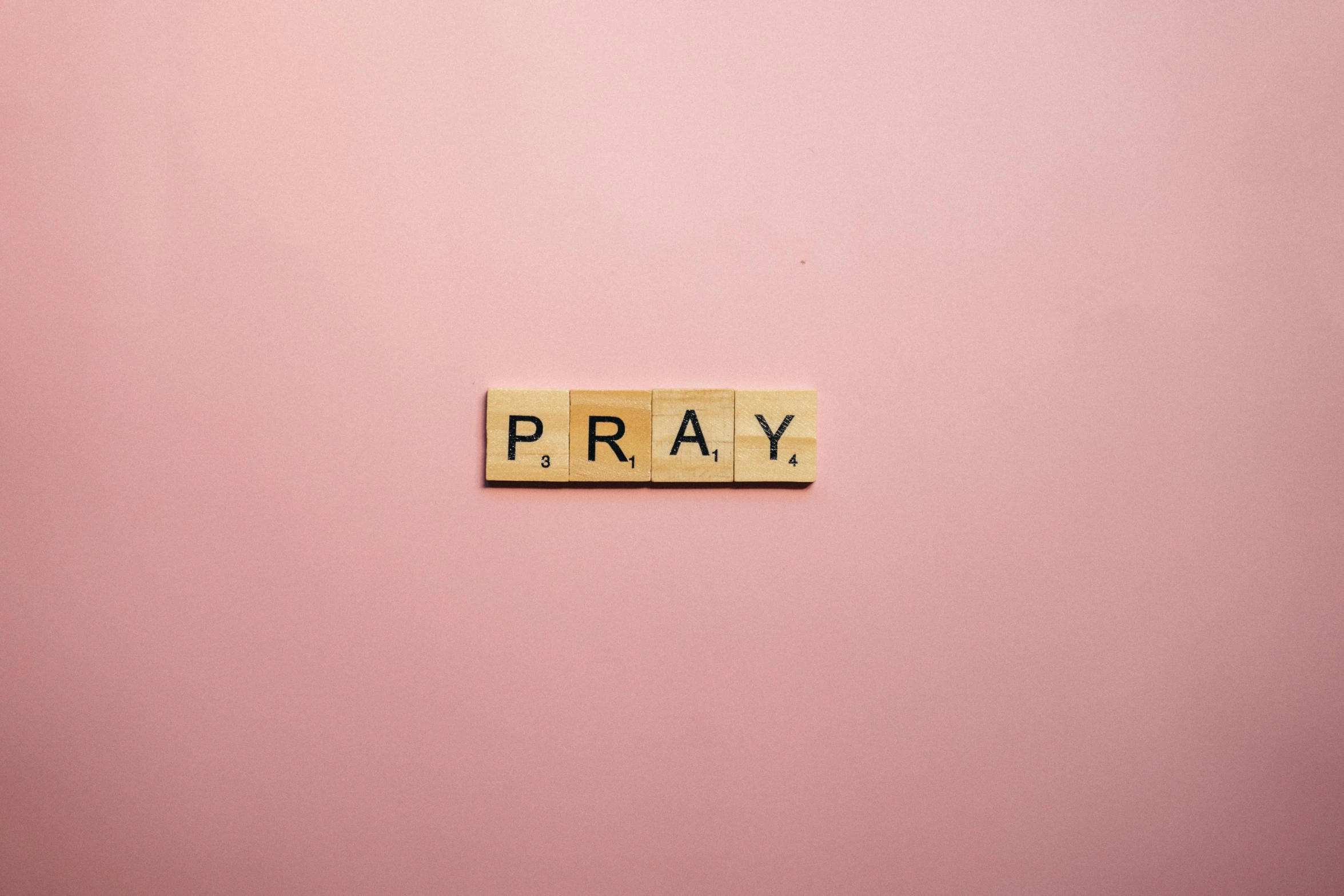 the word pray spelled with scrabbles on a pink background, by Carey Morris, pexels, 1 6 x 1 6, emergency, flat, a wooden