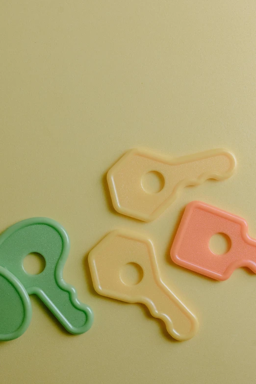 a group of keys sitting on top of a refrigerator, solid coloured shapes, pastelle, embossed, 7 0 - s