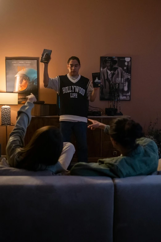 a group of people in a living room playing a video game, a hologram, reddit contest winner, throwing cards in the air, still from the twilight zone, jayson tatum as guerilla heroica, chappie in an adidas track suit