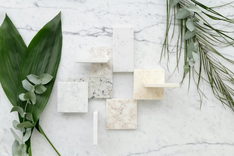 a marble cross sitting on top of a marble table, inspired by Patrick Pietropoli, botanic foliage, blocks, various styles, neutral colours