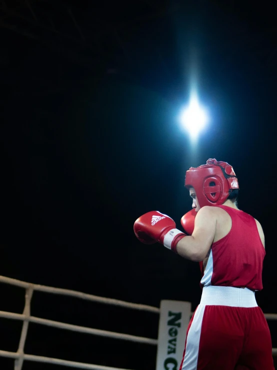 a couple of men standing next to each other in a boxing ring, pexels contest winner, symbolism, helmet view, olympics footage, (night), movie footage