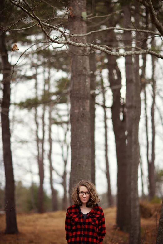 a woman standing in the middle of a forest, a portrait, by Andrew Stevovich, craigville, in a tree, long - shot, portrait”