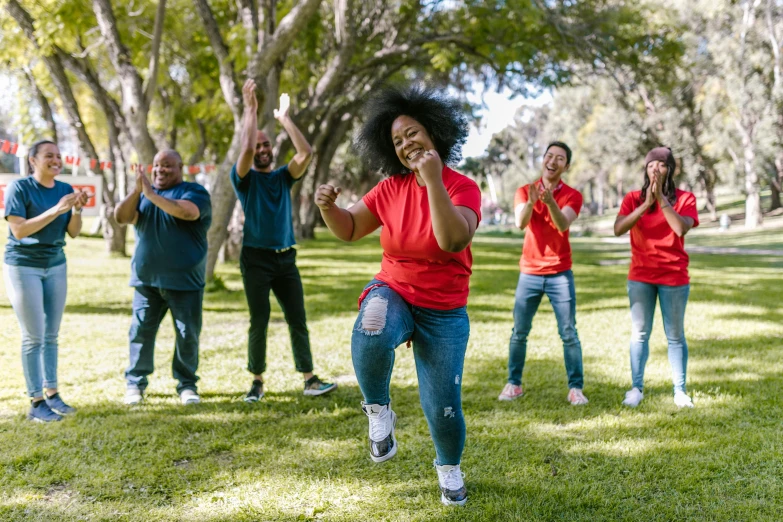 a group of people standing on top of a lush green field, dancing a jig, of a family standing in a park, sports clothing, avatar image