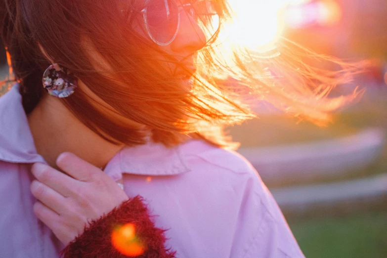 a woman with her hair blowing in the wind, trending on pexels, pink sunlight, red lens flare, wearing lab coat and a blouse, girl with brown hair