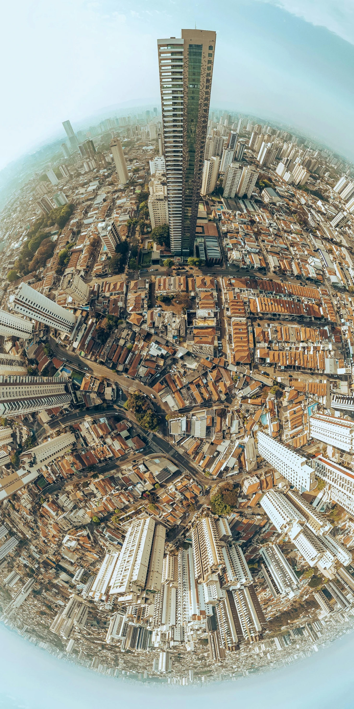 an aerial view of a city with tall buildings, by Luis Miranda, pexels contest winner, photorealism, fisheye 4, favela, brown, 3 6 0 panorama