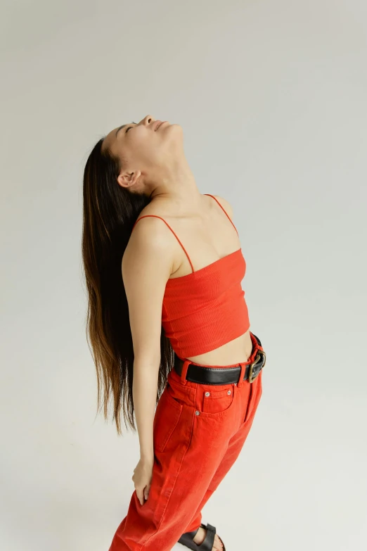 a woman in a red top and red pants, inspired by Ren Hang, trending on pexels, renaissance, vocal tract model, relaxed posture, hard breathing, bella poarch