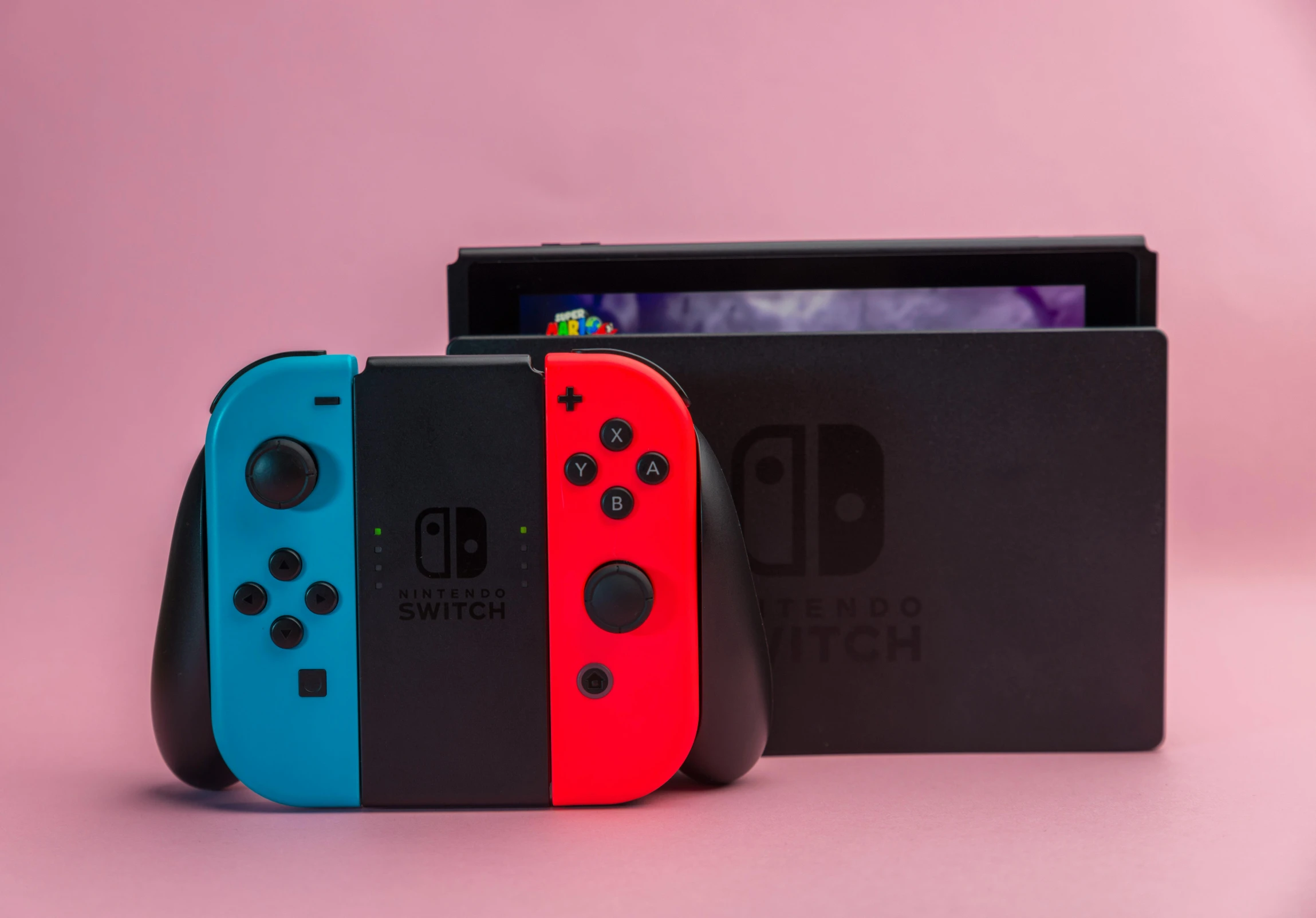 two nintendo switch controllers sitting next to each other, an album cover, by Julia Pishtar, unsplash, blue black pink, 256435456k film, pink and red color scheme, shot on sony a 7