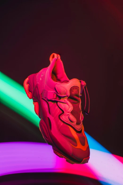 a pair of sneakers sitting on top of a colorful light, inspired by Lynda Benglis, trending on unsplash, all red, 2 1 savage, full body close-up shot, siggraph