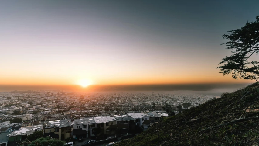 a view of a city from the top of a hill, unsplash contest winner, golden hour in pismo california, chile, sun rising, background image