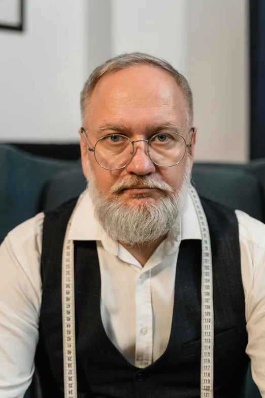 a man with a beard and glasses sitting in a chair, andrzej sykut, full white beard, lgbtq, lawyer