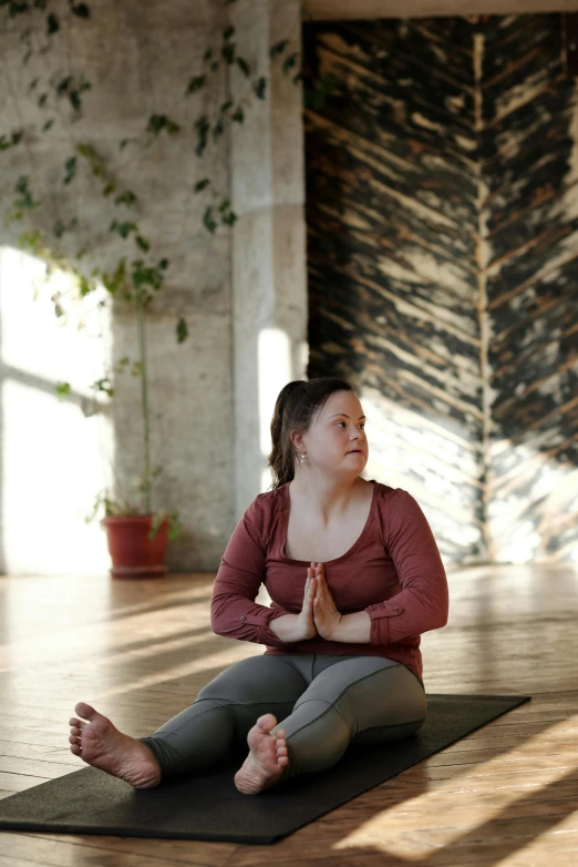 a woman sitting on a yoga mat in a room, a portrait, trending on unsplash, full-figure, low quality photo, brown, square