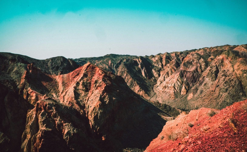 a group of people standing on top of a mountain, a colorized photo, pexels contest winner, red and brown color scheme, canyon topography, malibu canyon, background image