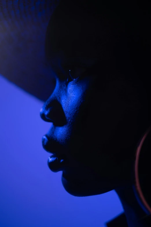 a close up of a person wearing a hat, by David Donaldson, blue and purle lighting, black young woman, silhouetted, ((portrait))