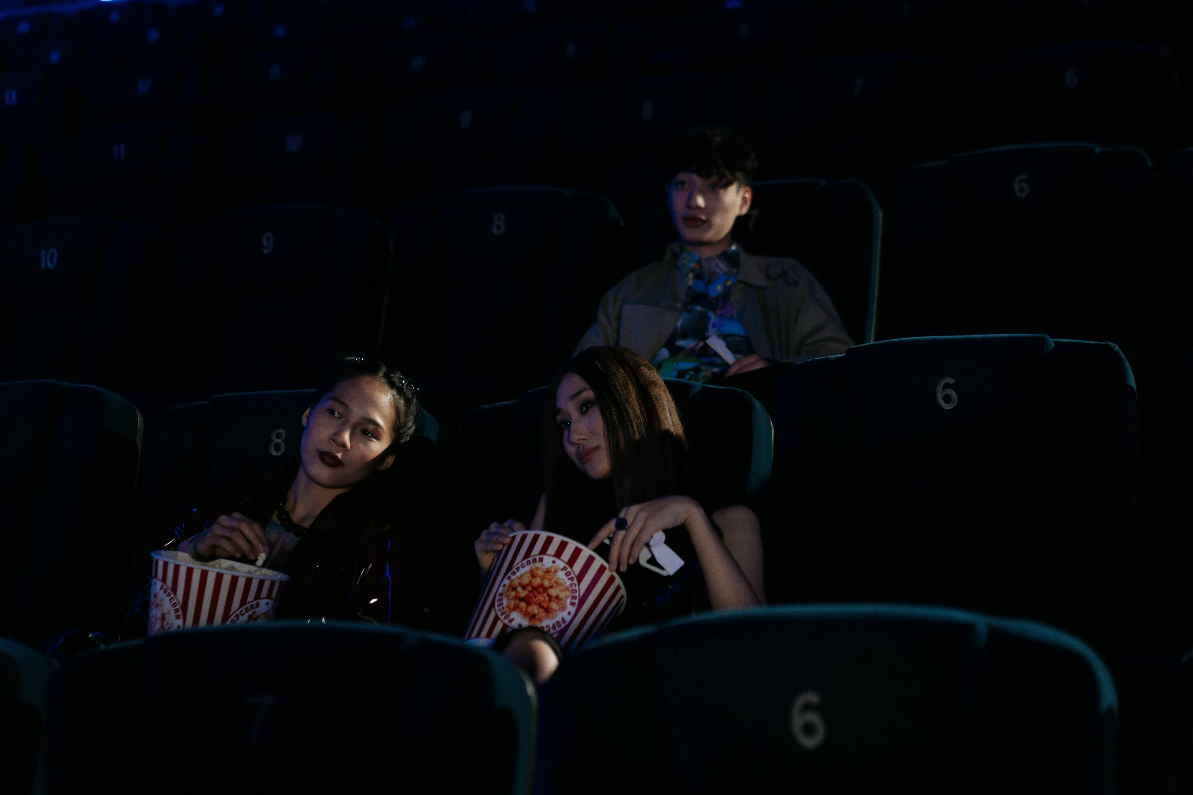 a group of people sitting in a movie theater, by Elsa Bleda, pexels, realism, yanjun chengt, movie still of the alien girl, at night, steve zheng