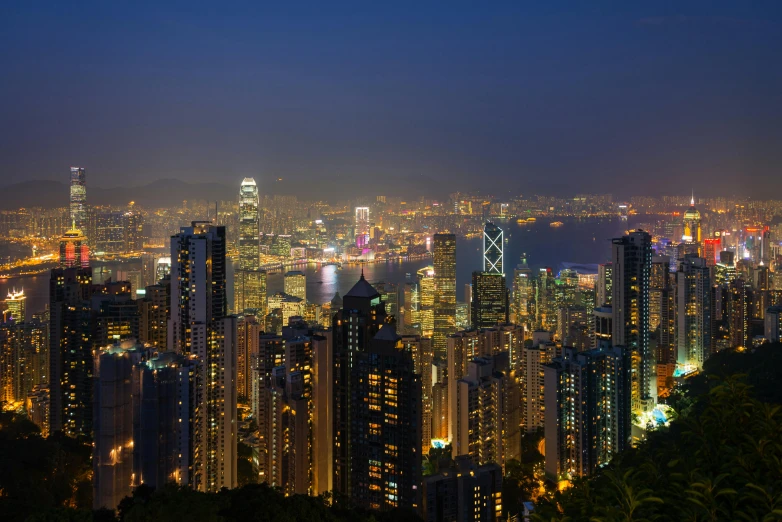 a view of a city at night from the top of a mountain, in hong kong, avatar image