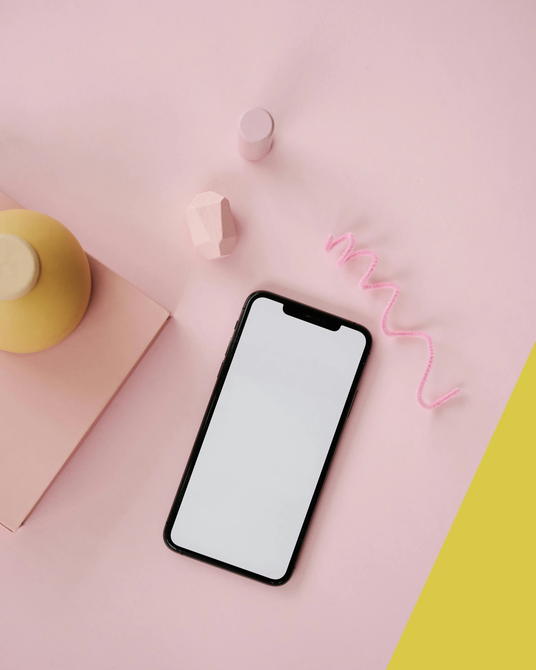 a phone sitting on top of a table next to a cup of coffee, trending on pexels, hypermodernism, pink and yellow, cosmetics, square, 8k octan photo