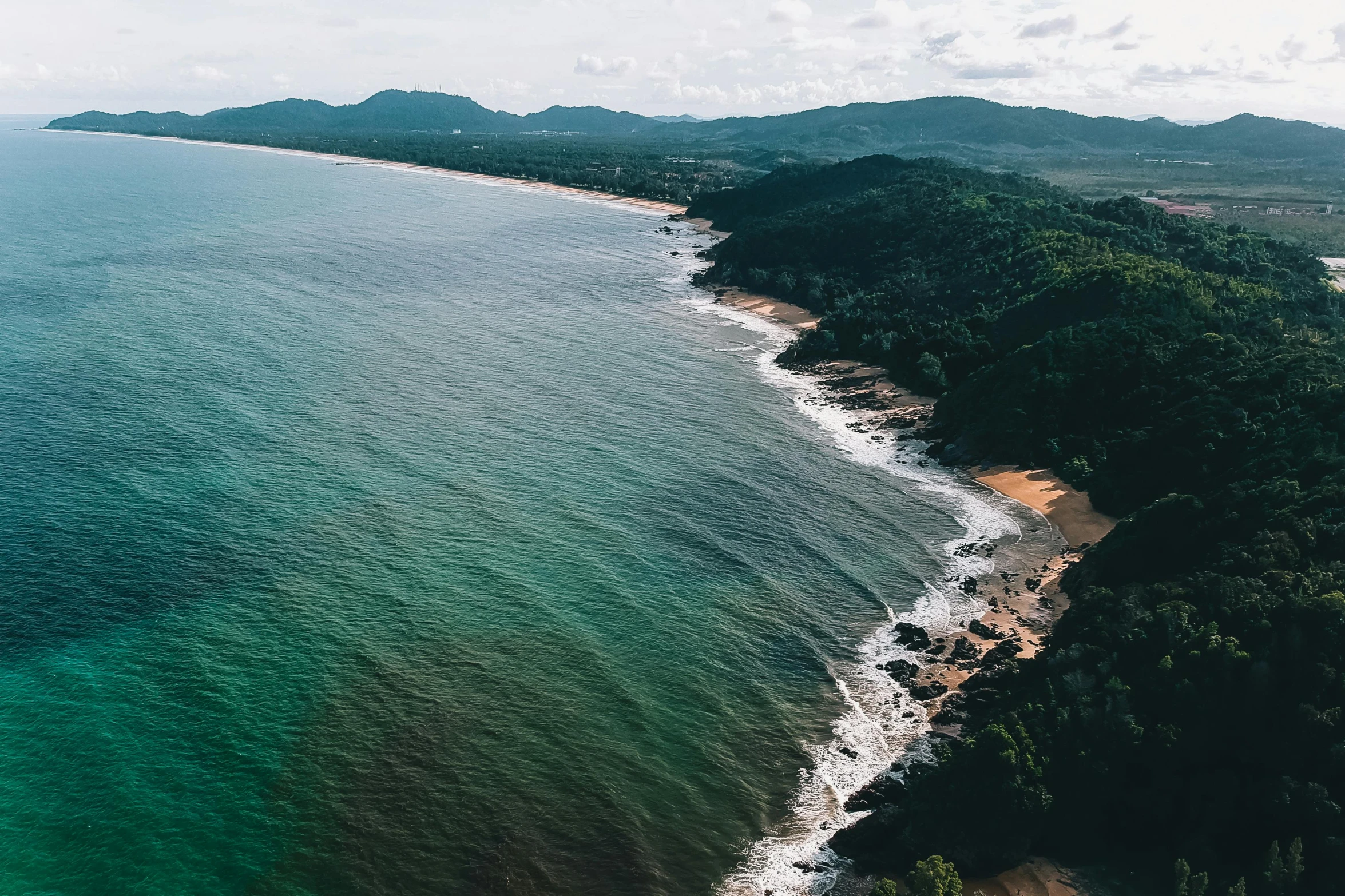 a large body of water next to a beach, pexels contest winner, coastline, thawan duchanee, thumbnail, aerial footage