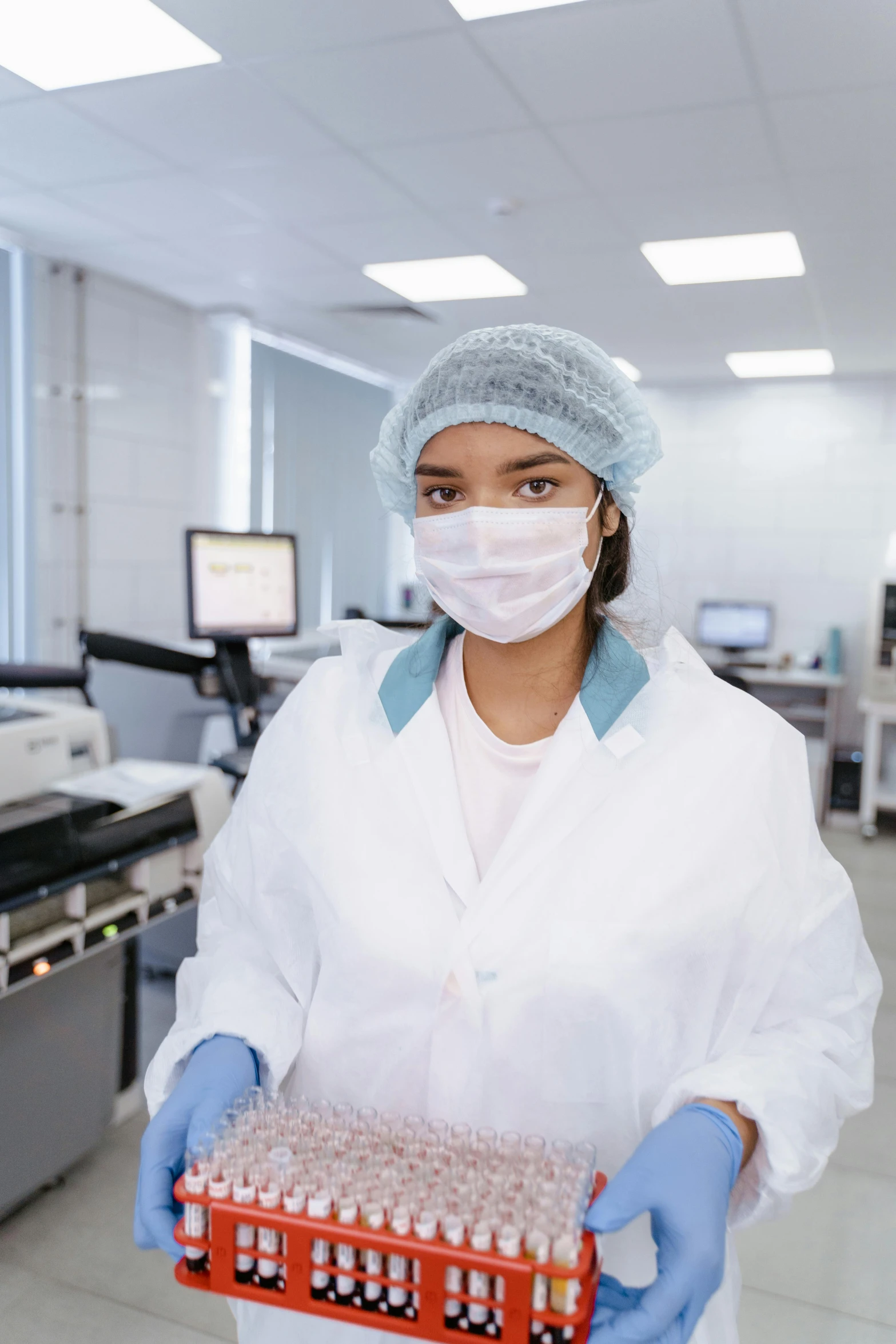 a woman in a lab holding a box of blood, shutterstock, surgical gown and scrubs on, engineering bay, instagram picture, aesthetics