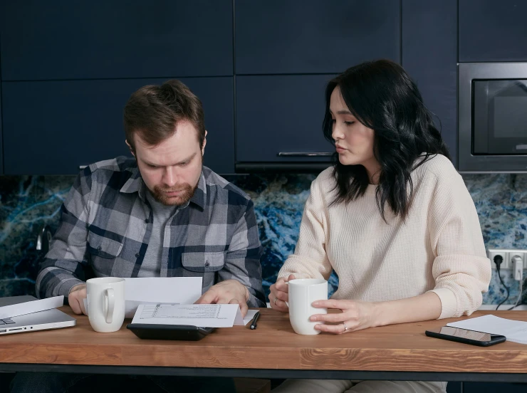 a man and a woman sitting at a kitchen table, garnishment, broken down, caulfield, profile image