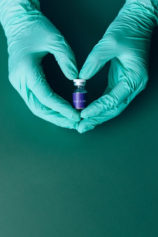 a person in blue gloves making a heart with their hands, pexels contest winner, aestheticism, vibrant vials, medical labels, purple, product shoot