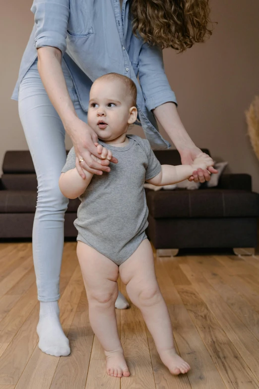 a woman playing with a baby in a living room, incoherents, standing on 2 feet, small steps leading down, high quality photo, thumbnail