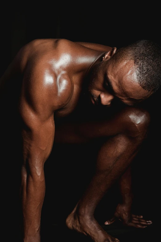 a man standing in the dark with his hands on his knees, an album cover, inspired by Terrell James, pexels contest winner, hyperrealism, chiseled muscles, covered in oil, profile image, brown body