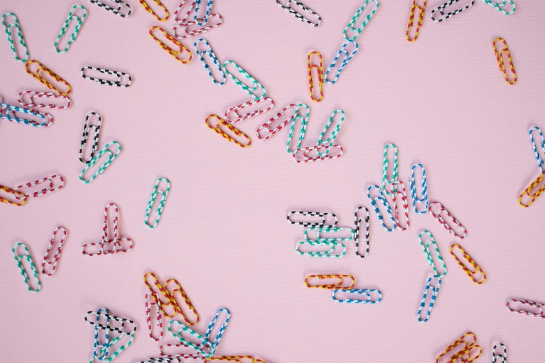 a bunch of paper clips laying on top of a pink surface, by Emma Andijewska, trending on pexels, maximalism, repeating pattern, candy decorations, 15081959 21121991 01012000 4k, polka dot