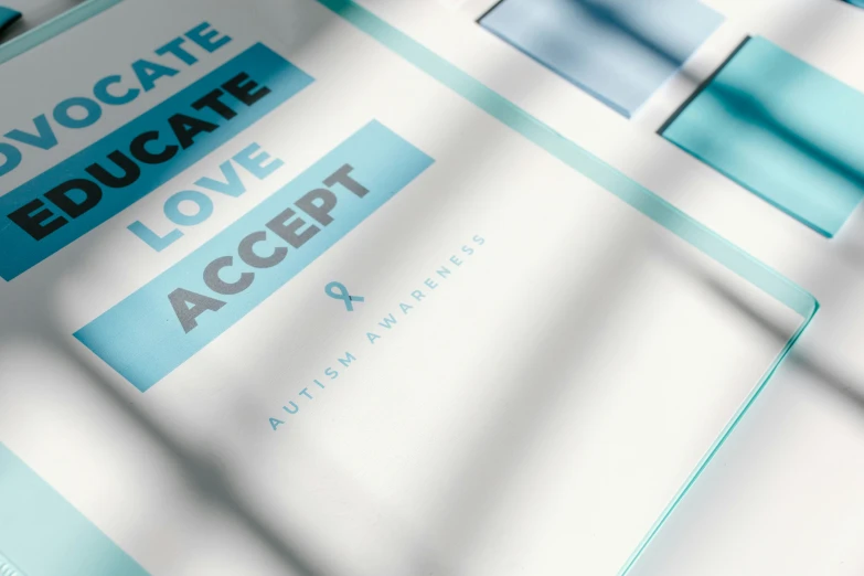 a close up of a brochure on a table, a poster, by Matija Jama, unsplash contest winner, white ribbon, gradient cyan, love hate love, acceptance