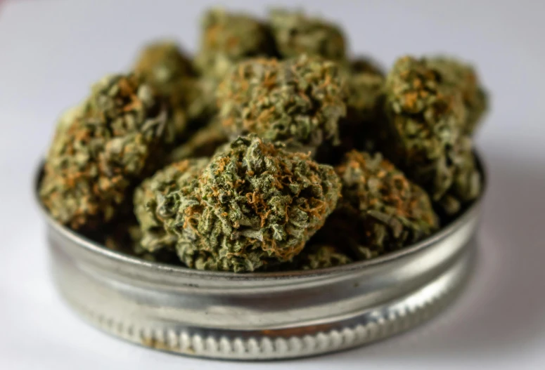 a tin of marijuana sitting on top of a table, pexels, ultra detailed close up, flower buds, portrait n - 9, thumbnail