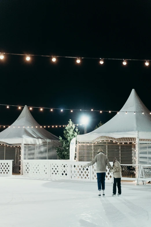 two people skating on an ice rink at night, renaissance, gazebos, designed for cozy aesthetics!, wine, marquee