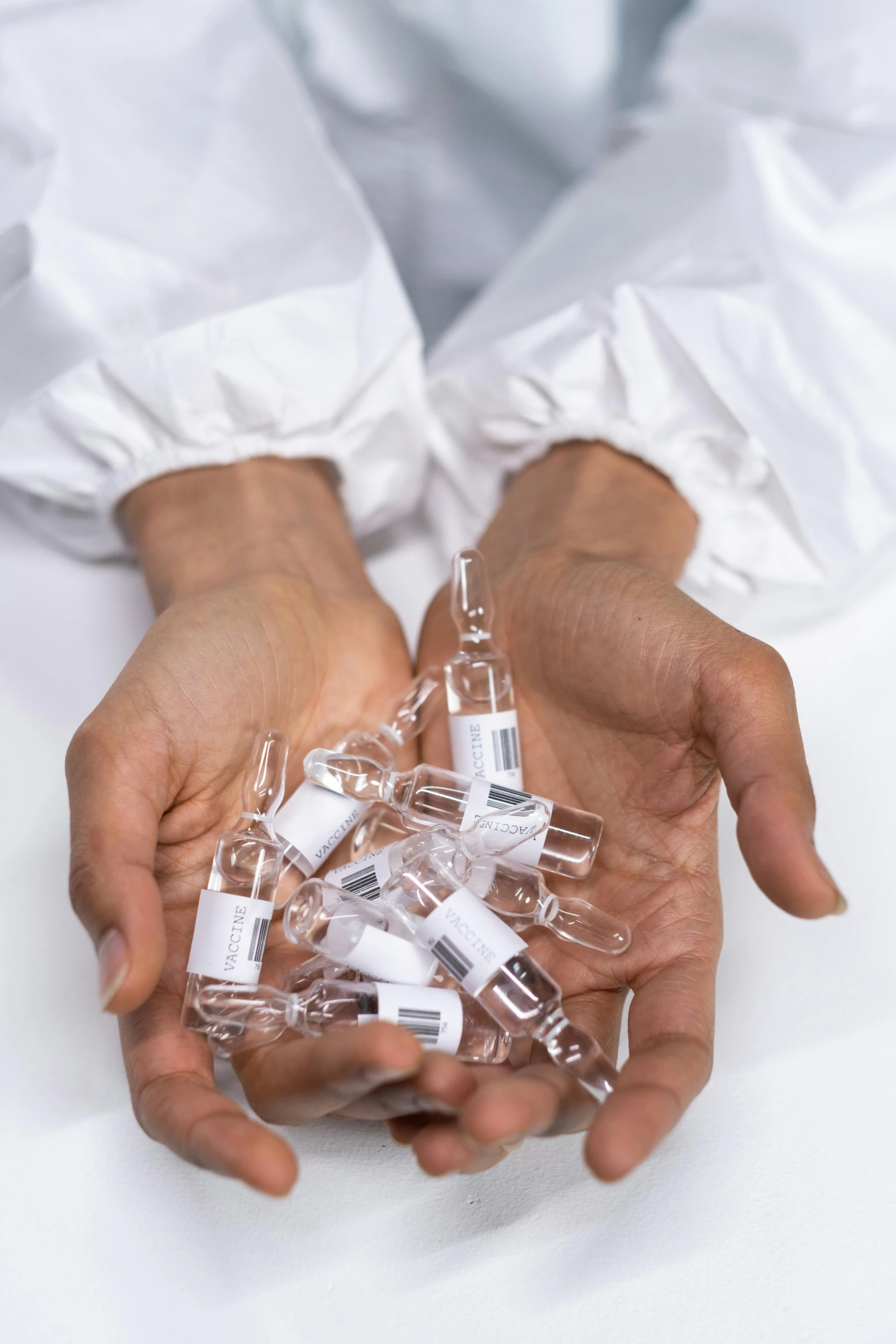 a person holding a bunch of pills in their hands, made of lab tissue, glass vials, 2010s, promo image