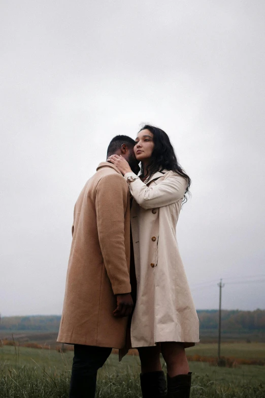 a man and woman standing next to each other in a field, pexels, renaissance, woman is in a trenchcoat, [ cinematic, kiss, promotional image