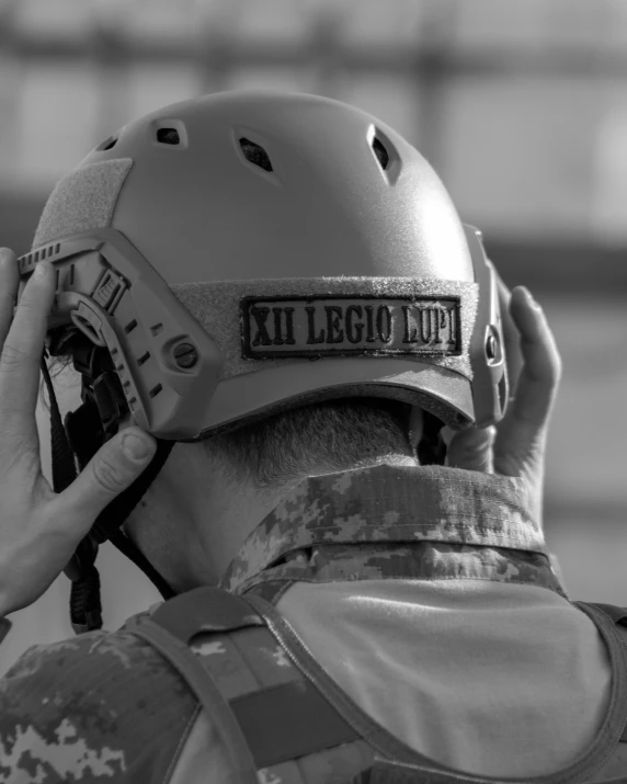 a man wearing a helmet talking on a cell phone, combat photography, profile image, uploaded, detail