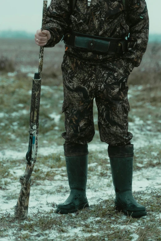 a man standing in a field holding a rifle, duck shoes, snow camouflage, promo image, multiple stories