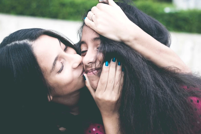 a couple of women that are kissing each other, pexels contest winner, hurufiyya, daughter, avatar image, hand on cheek, teenager