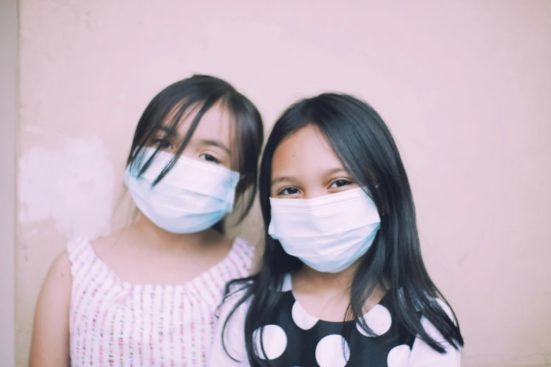 a couple of young girls standing next to each other, pexels, happening, masked doctors, kuntilanak, innocence, diy