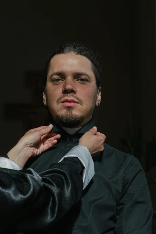 a man putting a tie on another man's neck, an album cover, inspired by Carlo Mense, renaissance, photo from a promo shoot, the actor, symmetrical face orelsan, wearing a tuxedo