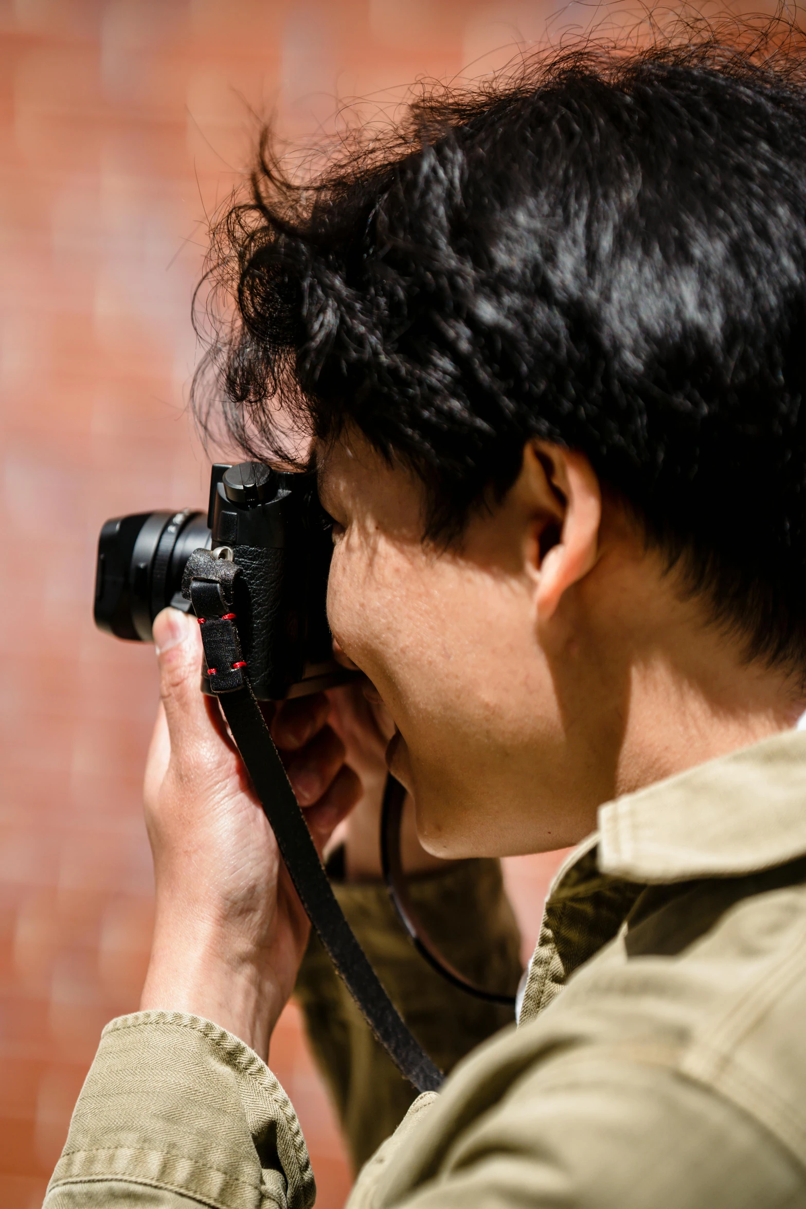 a man taking a picture with a camera, inspired by Bruce Davidson, unsplash, photorealism, close up shot from the side, color ( sony a 7 r iv, up close shot shinji aramaki, icon