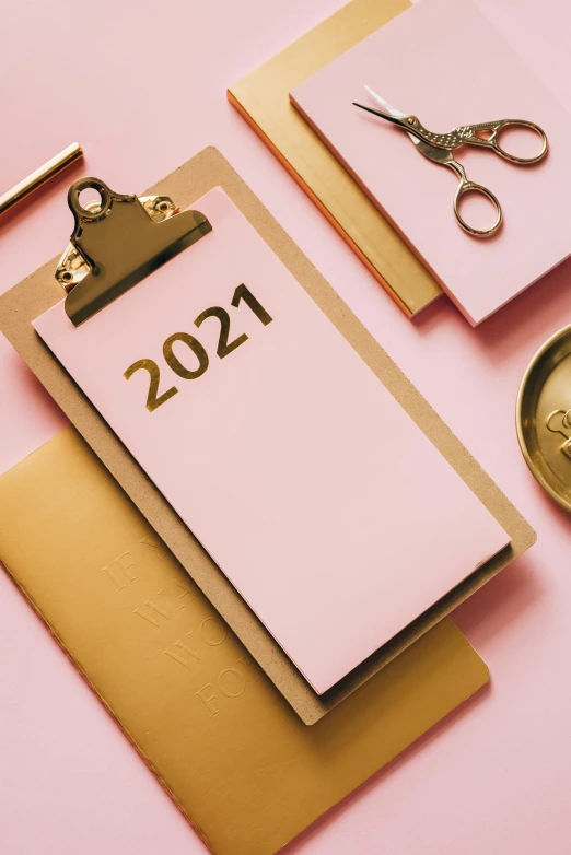 a notepad sitting on top of a clipboard next to a pair of scissors, by Julia Pishtar, happening, new years eve, thumbnail, pink, 2 0 2 1