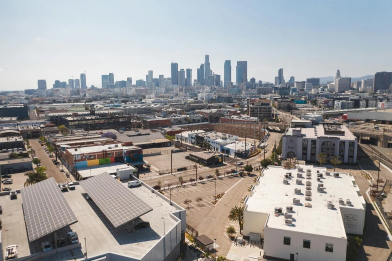 an aerial view of a city with a lot of buildings, by Carey Morris, gardena architecture, skyline view from a rooftop, as seen from the canopy, seen from the side